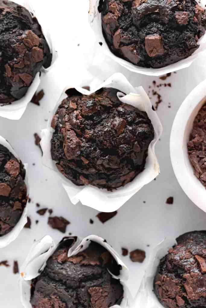 moist dark chocolate espresso muffins on a white marble backdrop