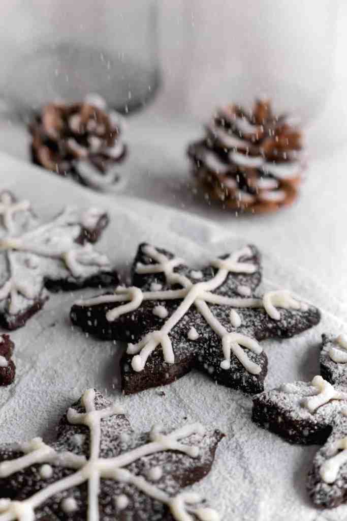 Snowy Snowfall scene - Baked Chocolate Snowflake Cookies Christmas baking with snow covered trees and pinecones