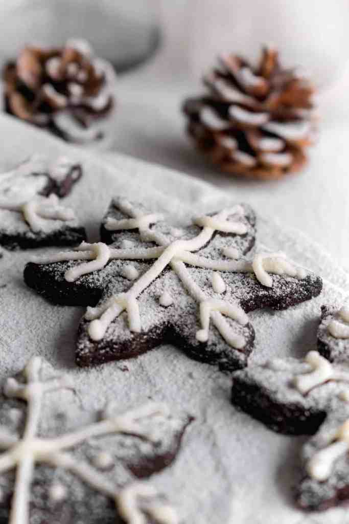 Snowy Snowfall scene - Baked Chocolate Snowflake Cookies Christmas baking with snow covered trees and pinecones