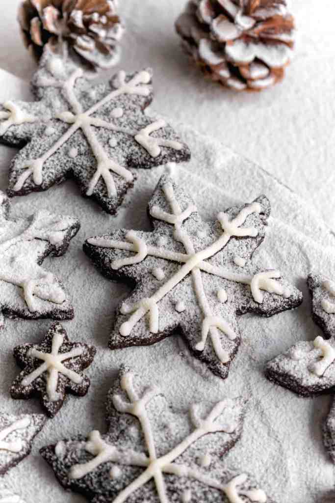 Snowy Snowfall scene - Baked Chocolate Snowflake Cookies Christmas baking with snow covered trees and pinecones