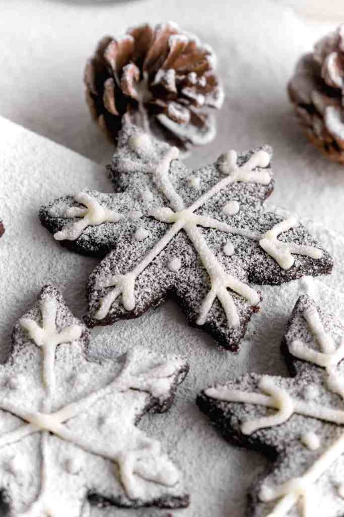 Snowy Snowfall scene - Baked Chocolate Snowflake Cookies Christmas baking with snow covered trees and pinecones