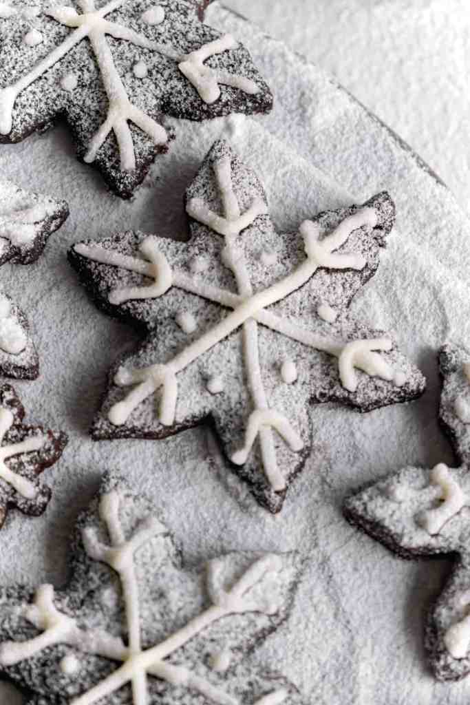 Snowy Snowfall scene - Baked Chocolate Snowflake Cookies Christmas baking with snow covered trees and pinecones