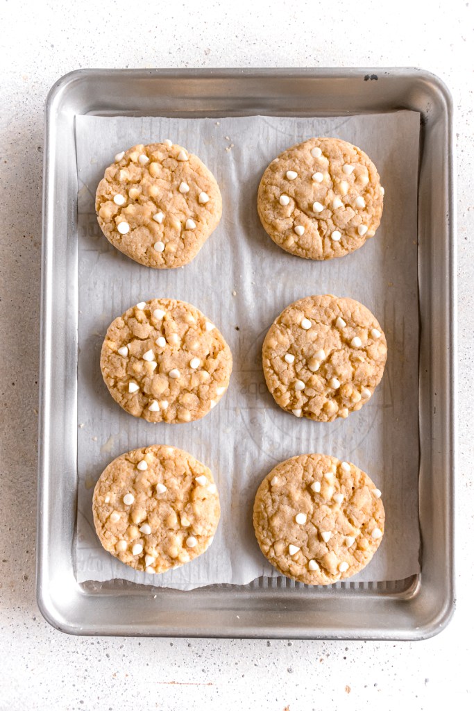 baked lemon and white chocolate cookies in a baking tray.
