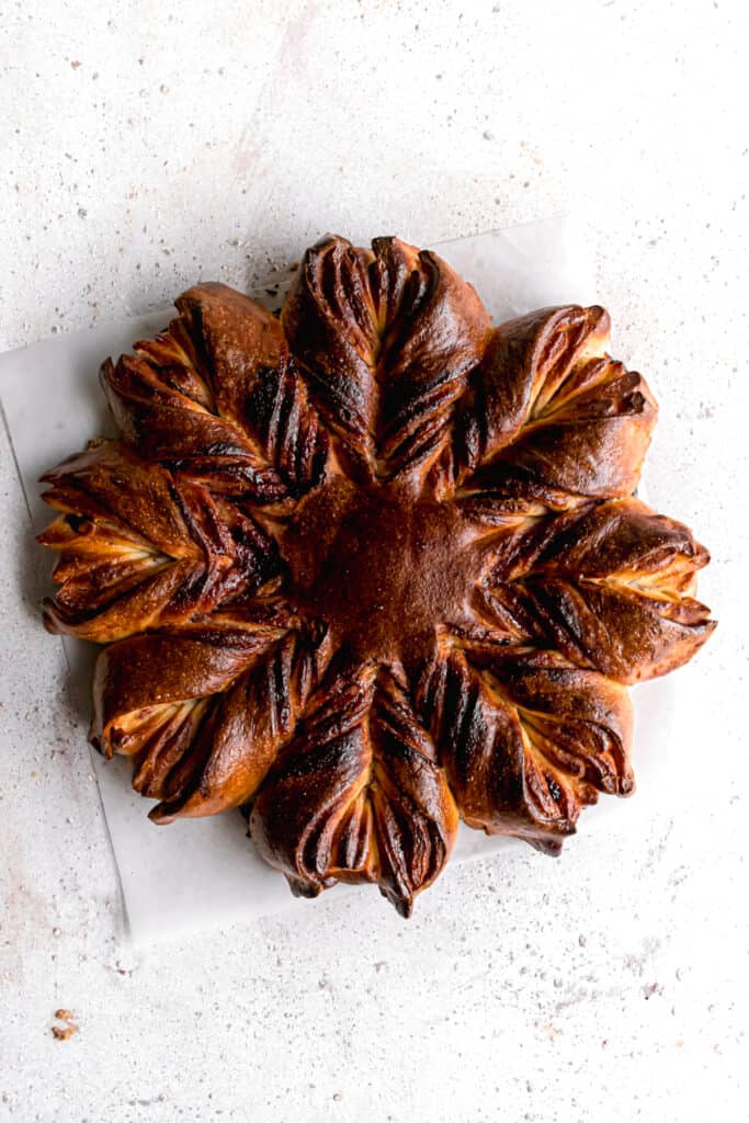 Baked Blueberry jam cream cheese star bread on a parchment paper